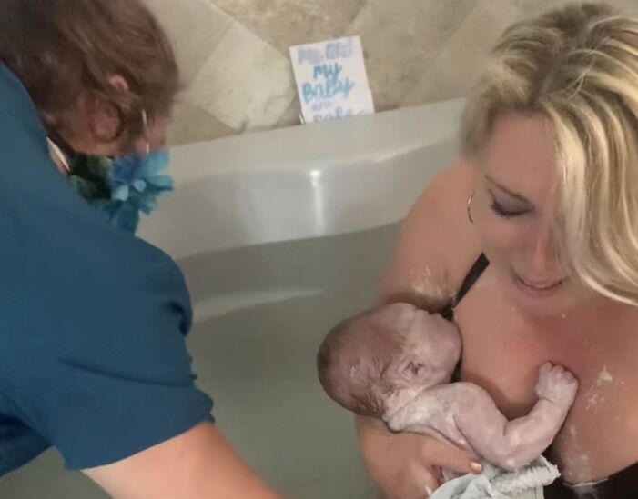 Midwife helps with newborn