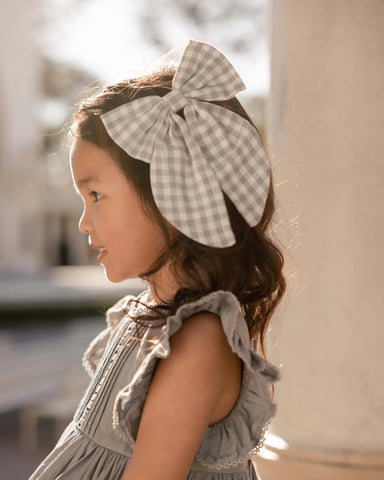 Girl wearing Noralee gingham sailor bow