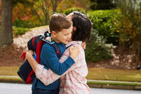 Child hugging mom before school