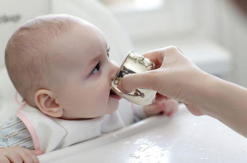 baby drinking from cup