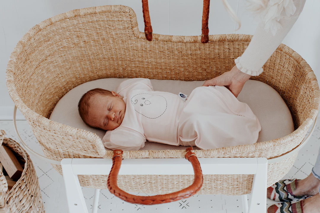 baby sleeping in zen one in a bassinet